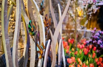Stone grass fish sculpture with tulips